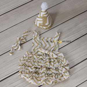 Back view of White & Gold Glimmer Chevron Girls' Cake Smash Outfit. Romper, headband & party hat.